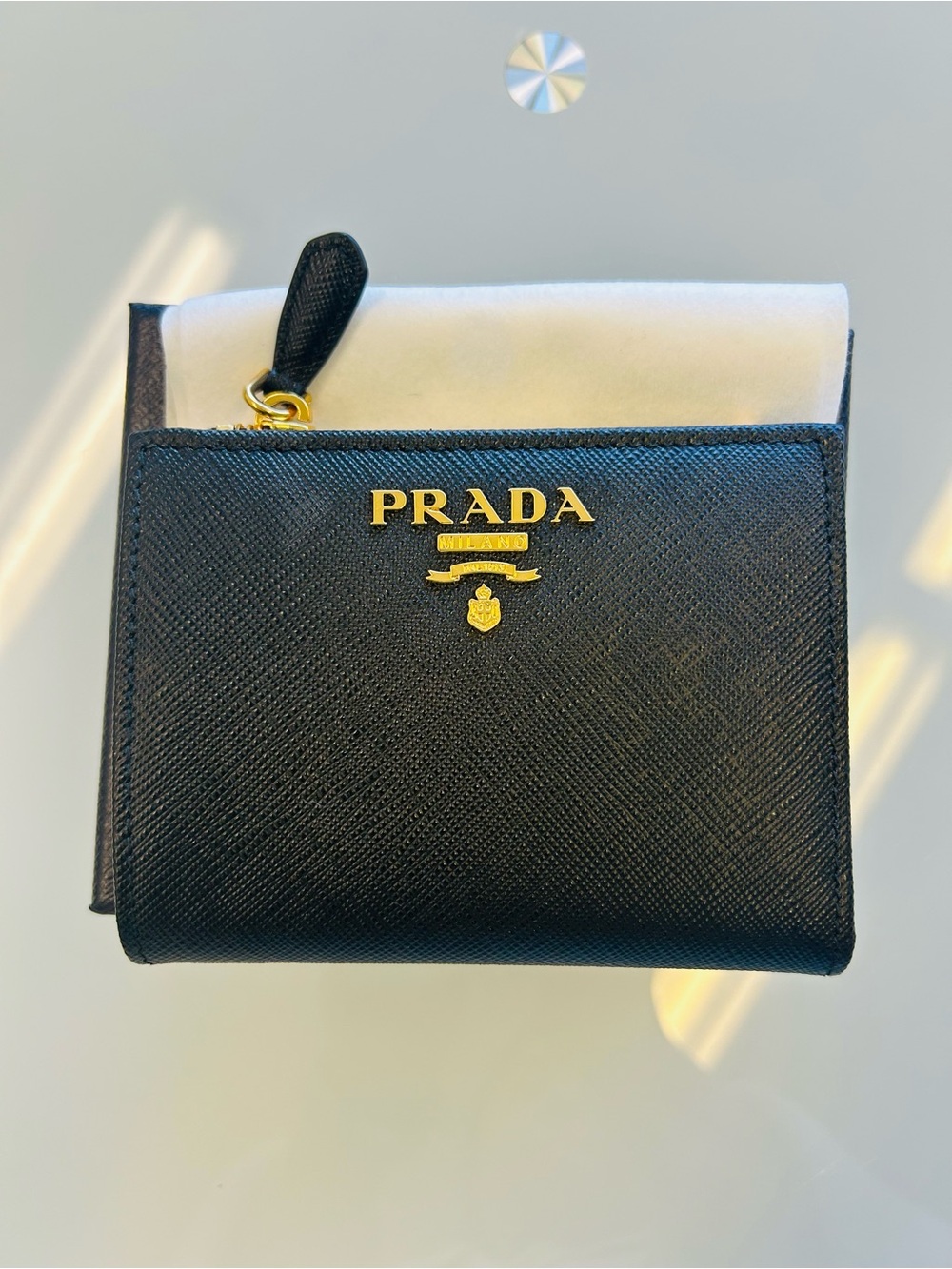 Authentic Prada Small Saffiano Leather Wallet  with gold-tone hardware.